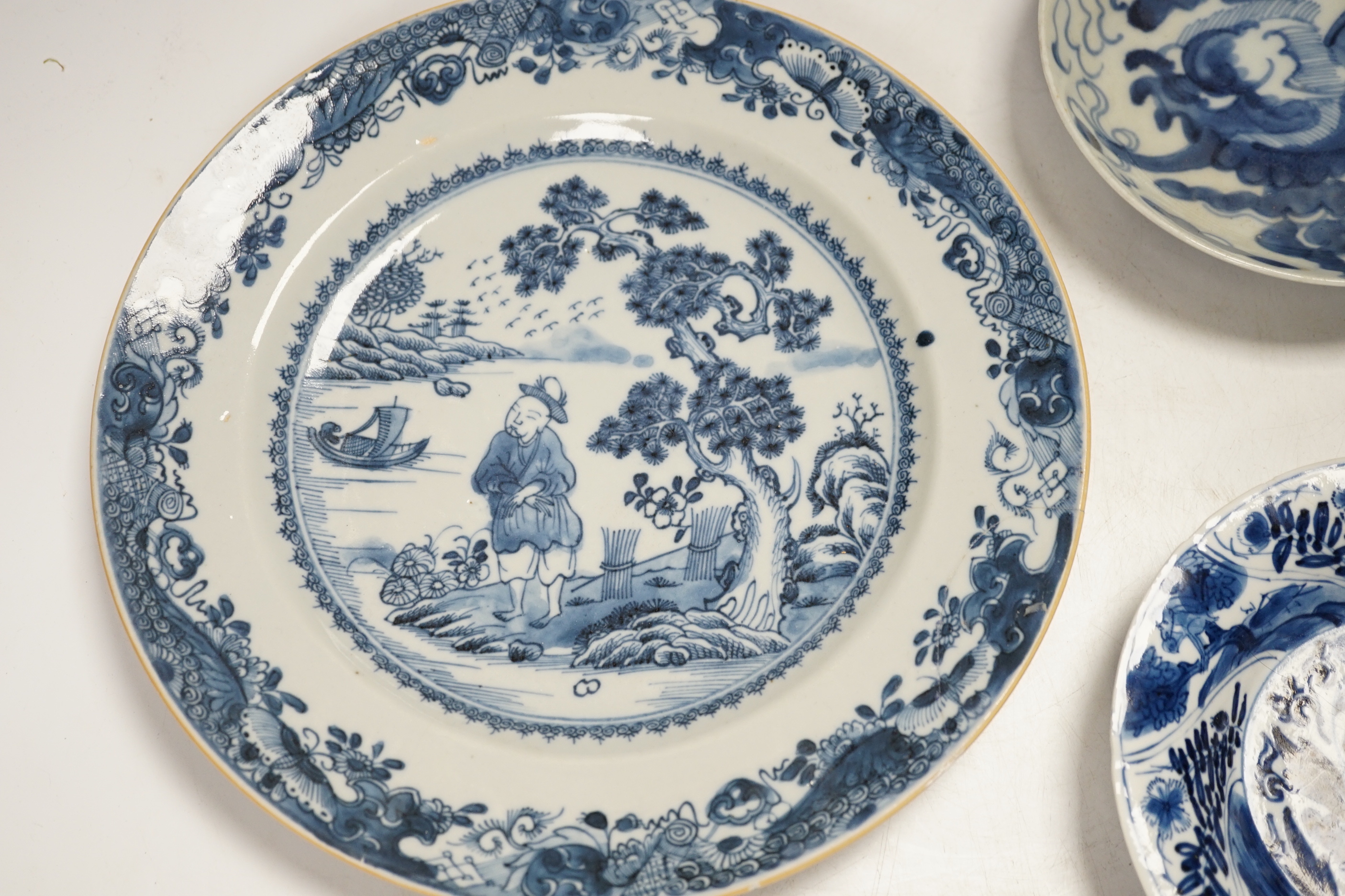 An 18th century Chinese export blue and white dish together with two others, largest 26cm